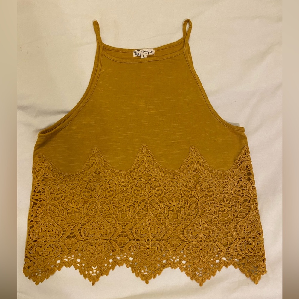 Gold/mustard colored tank. Hits at waist, with a crochet piece on front.